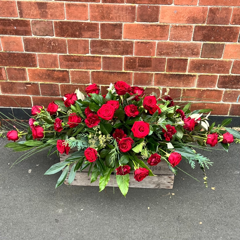 Red rose & carnation casket spray