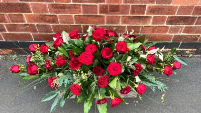 Red rose & carnation casket spray